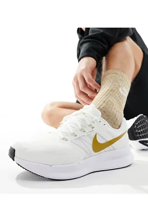 Nike Run Swift sneakers in and gold