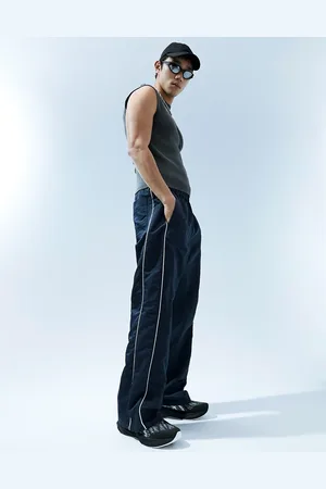 ASOS Baggy nylon track pants in with white piping