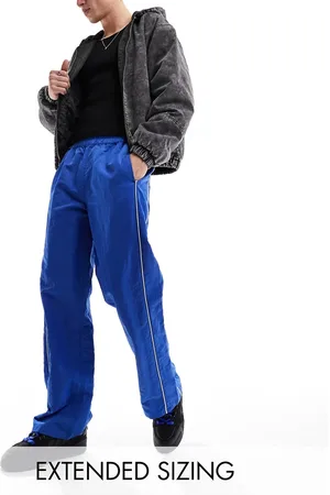 ASOS Baggy nylon track pants in with white piping