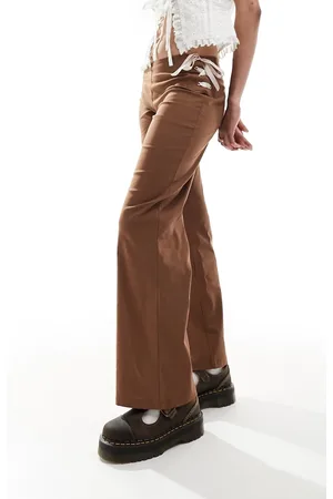 Reclaimed Flare pants in with pink bows & ribbon