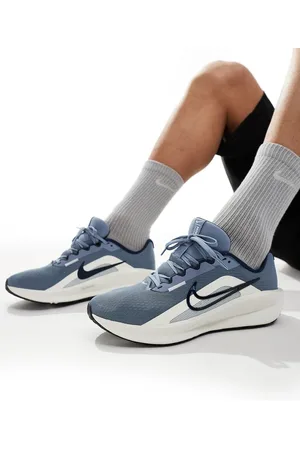 Nike Downshifter 13 sneakers in light blue and
