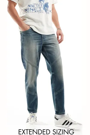 ASOS Tapered fit jeans with paneling in a vintage tint dark