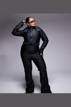 ASOS Curve belted ski suit with slim kick leg and faux fur hood in gloss