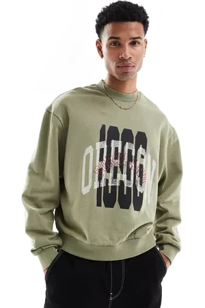ASOS Boxy oversized sweatshirt with acid wash and layered print in