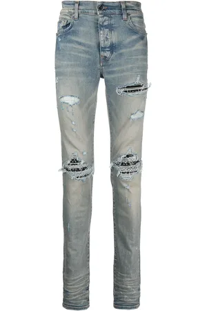 AMIRI Skinny jeans con detalles rasgados MX1