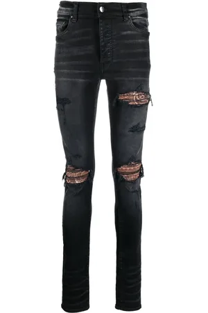 AMIRI Skinny jeans con detalles rasgados