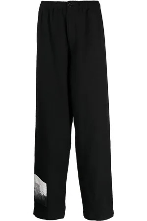 UNDERCOVER Pantalones con parche gráfico