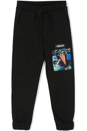 VERSACE Pants con bolsillos y solapa