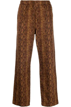 STUSSY Pantalones con estampado de piel de serpiente