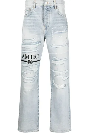 AMIRI Jeans con logo bordado y detalles rasgados