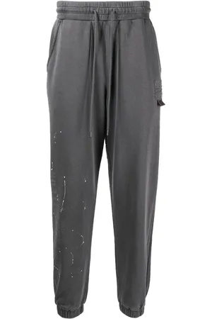 Musium Div. Pants con logo estampado y motivo de salpicaduras