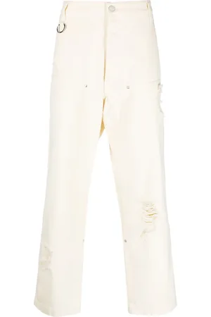 Etudes Jeans holgados con detalles rasgados