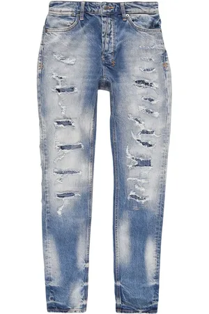 KSUBI Jeans slim con detalles rasgados