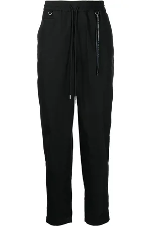 MASTERMIND Pantalones tapered con logo estampado