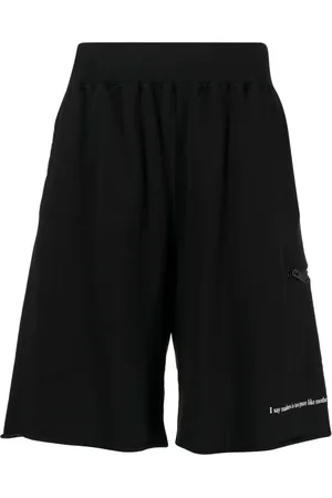 UNDERCOVER Shorts deportivos con eslogan estampado