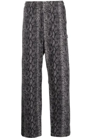 STUSSY Pantalones con estampado de piel de serpiente