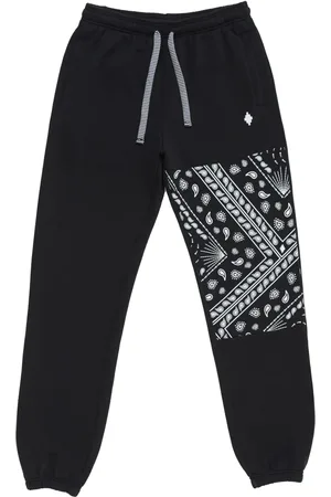 MARCELO BURLON Pants con paneles y estampado de bandana