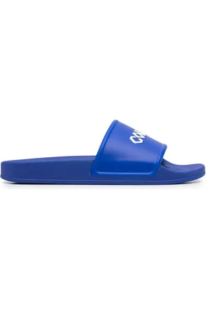 MARCELO BURLON Flip flops con logo estampado