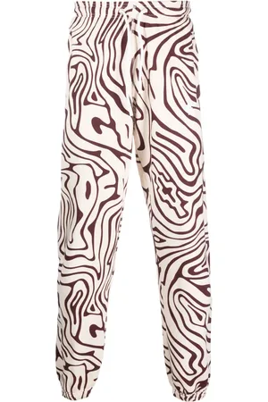 MARCELO BURLON Pants con remolino estampado