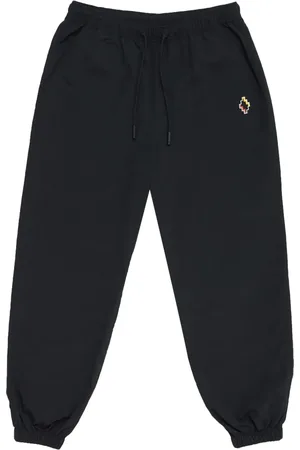 MARCELO BURLON Pants con cruz bordada