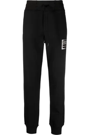 VERSACE Pants con logo estampado