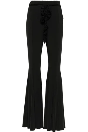 ROTATE Pantalones con tiro alto y detalle de volantes