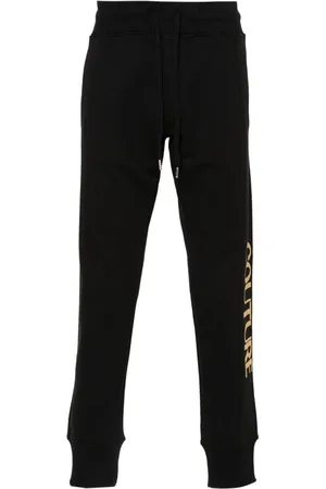 VERSACE Pants con logo estampado