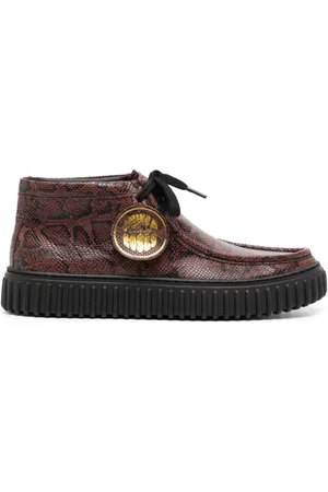 MARTINE ROSE Botas con estampado de piel de serpiente