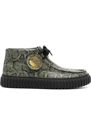 MARTINE ROSE Botas con estampado de piel de serpiente