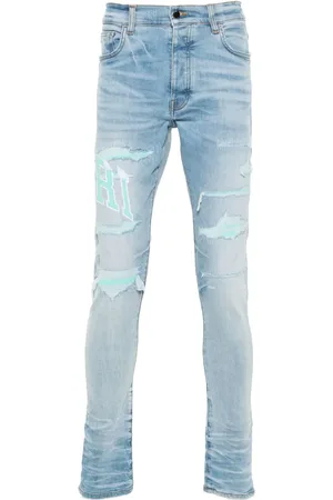 AMIRI Skinny jeans estilo universitario con logo