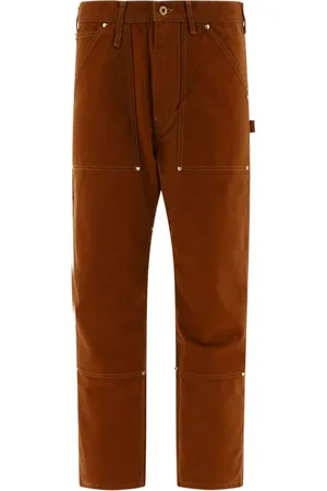 HUMAN MADE Pantalones rectos con apliques dorados