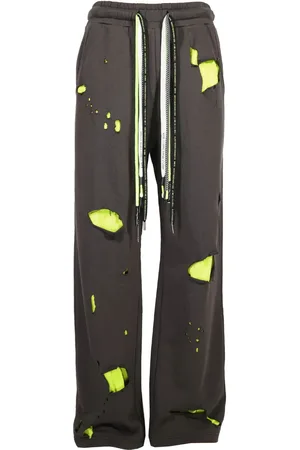 MOSTLY HEARD RARELY SEEN Pants con detalles rasgados