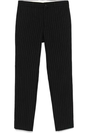 Comme des Garçons Pantalones con rayas diplomáticas estampadas