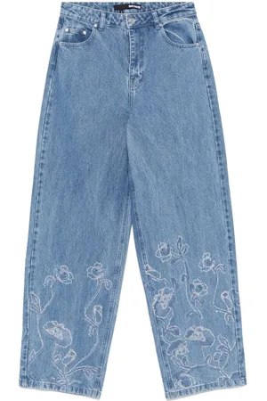 ROTATE Jeans anchos con detalles de strass