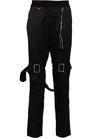MASTERMIND Pantalones con correas del logo