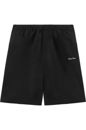 UNDERCOVER Shorts con texto estampado