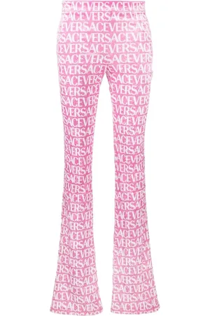 VERSACE Pantalones acampanados con logo estampado