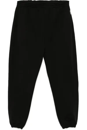 Represent Pants con inicial en los tobillos
