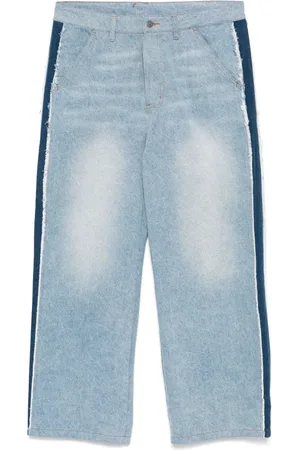 KIDSUPER STUDIOS Jeans con rayas estampadas en colaboración con Ronaldinho