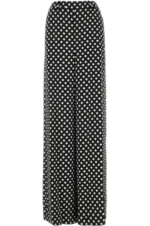 Saint Laurent Pantalones de seda con estampado de lunares