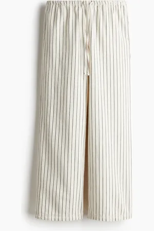 H&M Pantalón de denim con cordón de ajuste