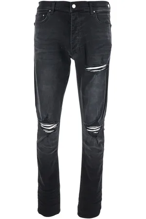 AMIRI Jeans With Ripped Details On The Front And Logo Patch On The Rear In Denim Man
